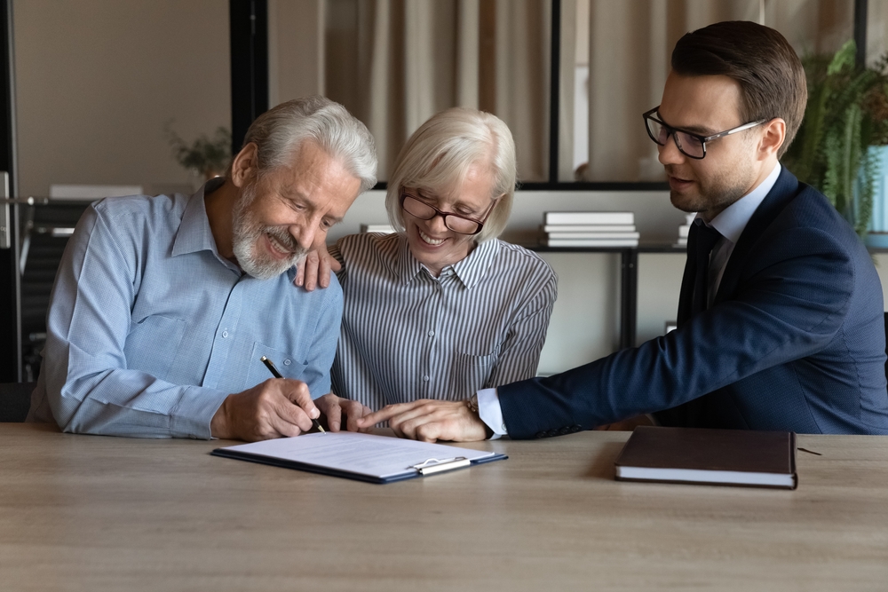 Photo of Couple Signing Document
